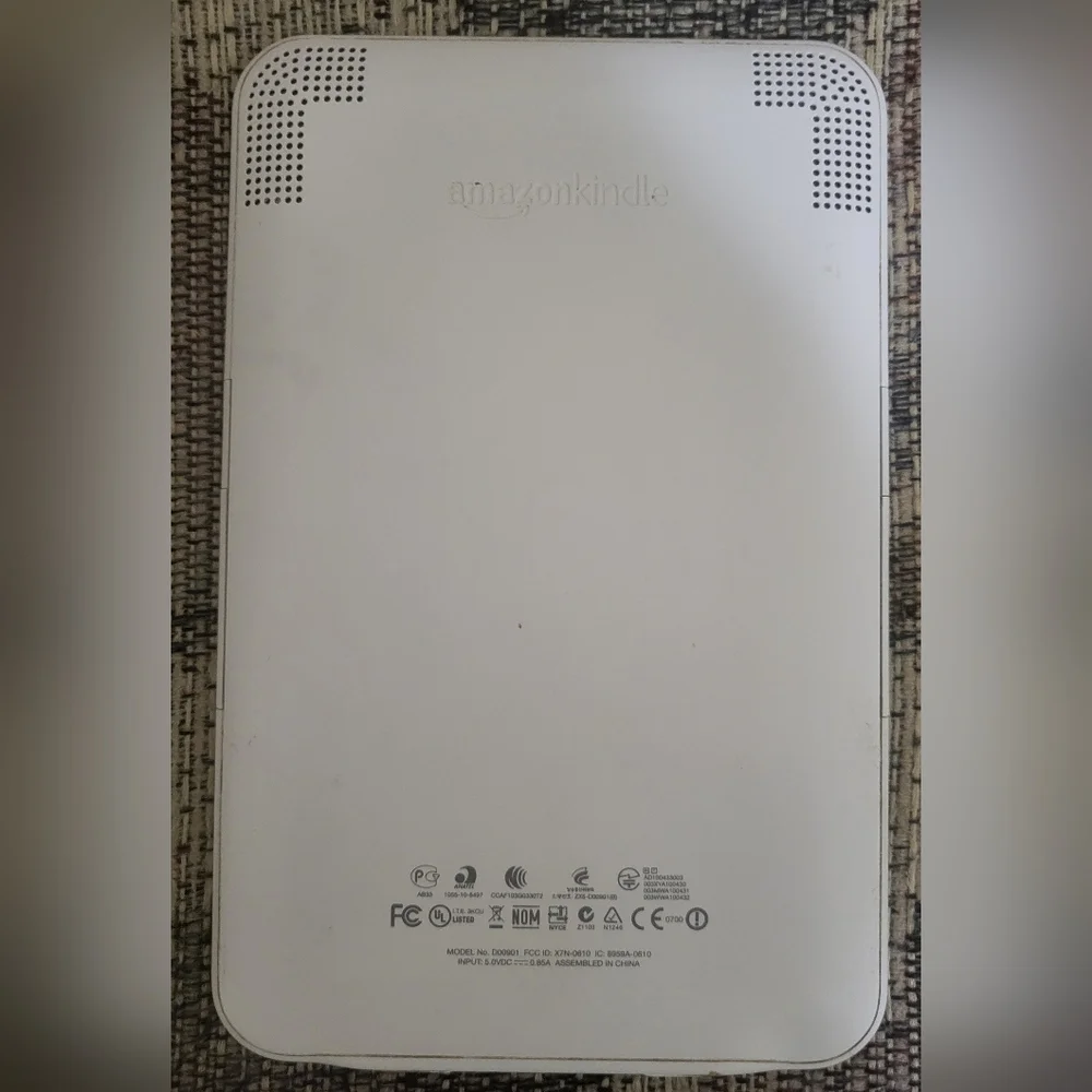 Amazon Kindle with charging cord and Thirty-one carrying case